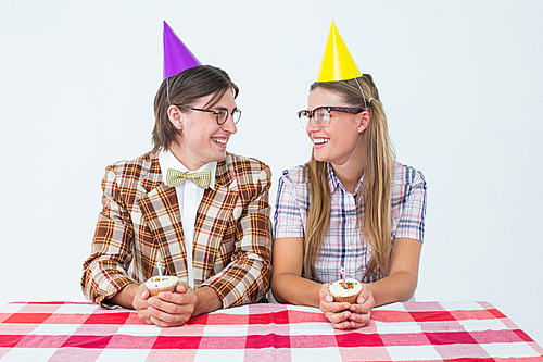 Geeky hipsters celebrating birthday on white background