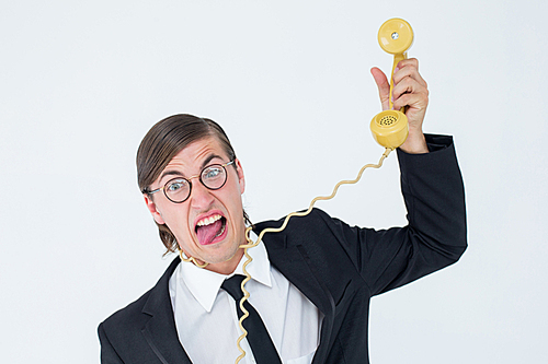 Geeky businessman being strangled by phone cord on white background