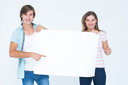 Hipster couple holding poster on white background