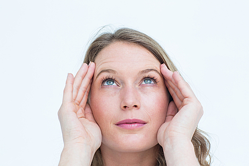 Pretty hipster with headache on white background