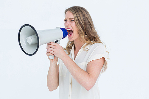 Woman shouting through a loudspeaker on white background