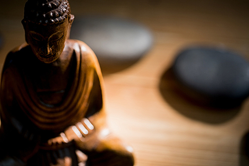 Wooden buddha statue on table shot in studio