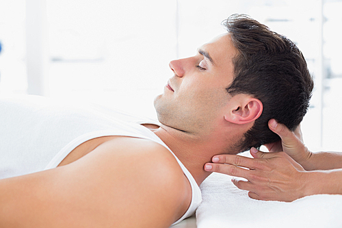 Man receiving neck massage in medical office