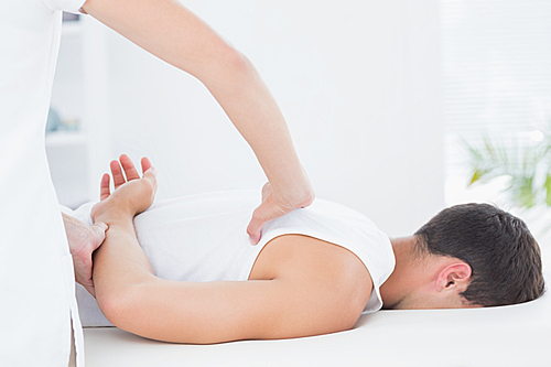 Man receiving back massage in medical office
