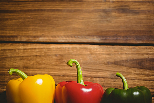 Three peppers on chopping board with copy space