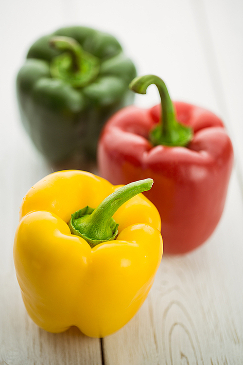 Three peppers on chopping board with copy space