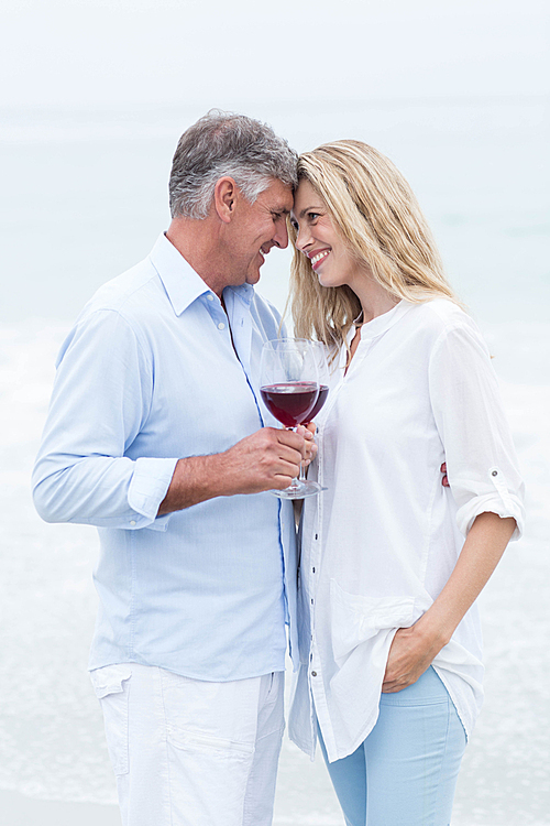 Happy couple smiling at each other and toasting