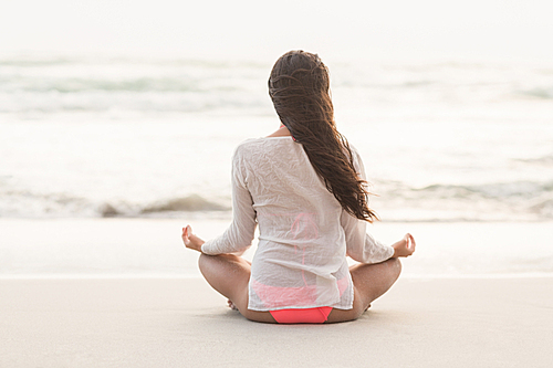 Sporty brunette sitting in lotus pose