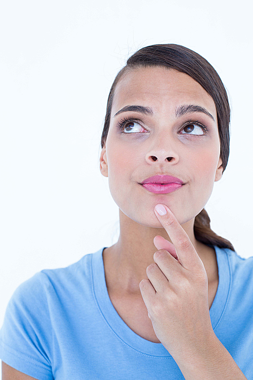 Thoughtful woman looking up with finger on chin