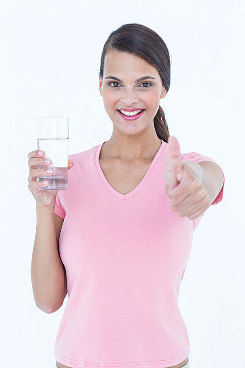 Beautiful woman drinking glass of water with thumb up