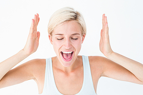 Happy blonde woman screaming with hands up