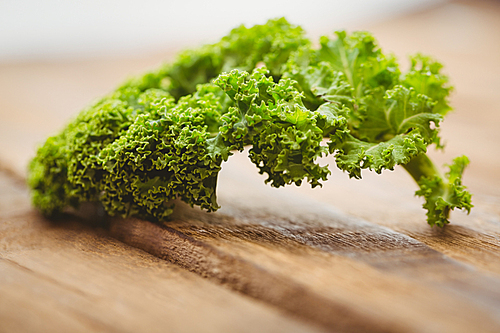 Curly parsley on wooden board