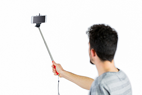 Casual man using a selfie stick