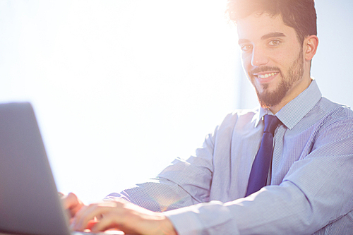 Businessman using laptop at desk