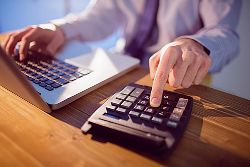 Businessman using laptop at desk