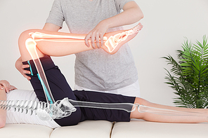 Digital composite of Highlighted bones of woman at physiotherapist