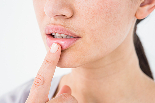 Woman pointing her lip on white background