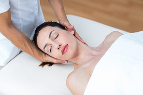 Physiotherapist doing neck massage in medical office
