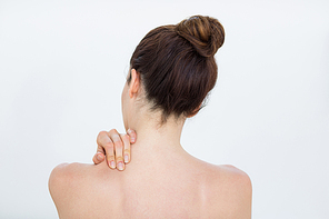 Woman touching her shoulder in medical office