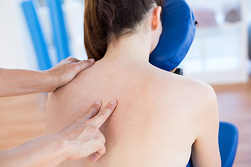 Woman having back massage in medical office