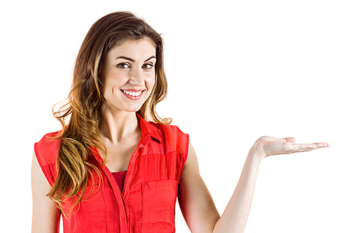 Pretty brunette presenting with her hand on white background