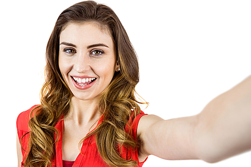 Pretty brunette smiling at camera on white background