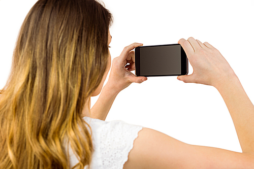 Woman taking a selfie on smartphone on white background