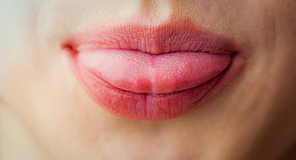 Woman sticking her tongue out in close up