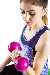 Fit woman lifting pink dumbbell  on white background