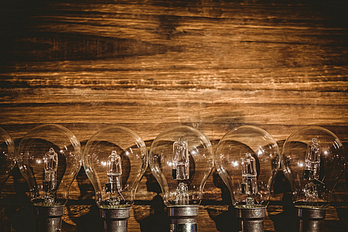 Row of light bulb on wooden table