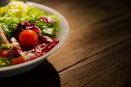 Healthy salad on wooden table