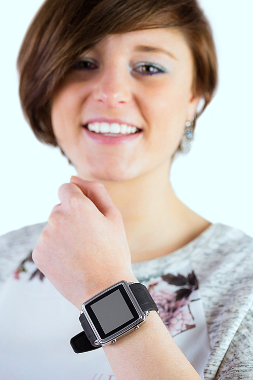 Pretty brunette wearing her smartwatch on white background