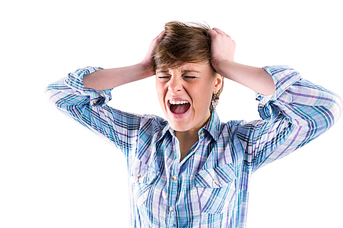 Pretty brunette shouting with hands on head on white background