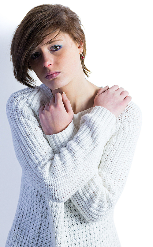 Sad pretty brunette  with arms crossed on white background