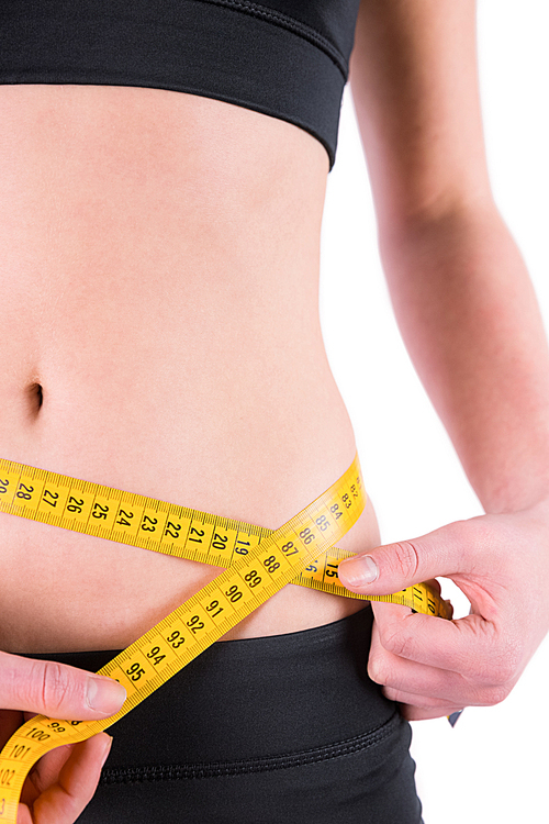 slim woman measuring waist with tape measure on white background