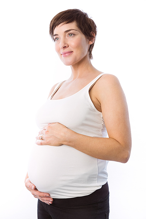 Pregnant woman holding her bump on white background