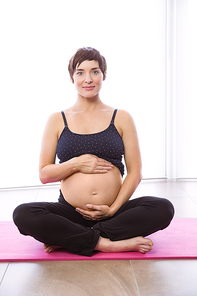 Pregnant woman keeping in shape at home