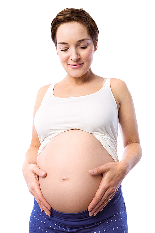 Pregnant woman holding her bump on white background