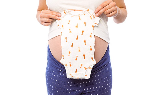 Pregnant woman holding baby clothes on white background