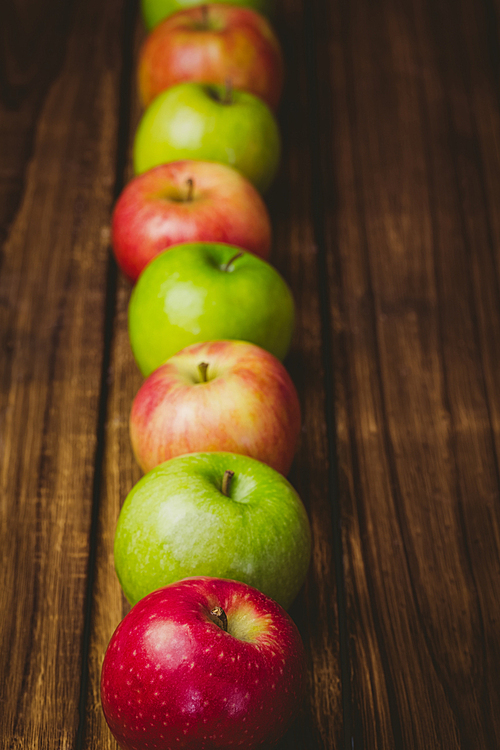 Fresh colorful apples on wooden background