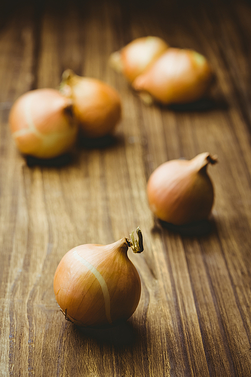 Fresh onions on wooden background