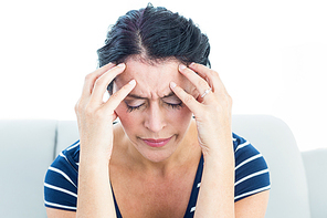 Woman having migraine on white background