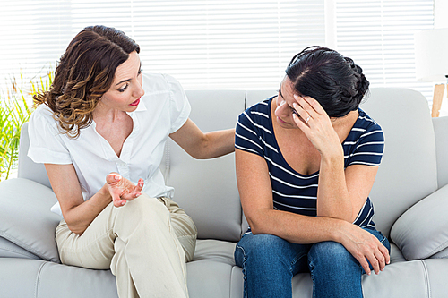 Therapist comforting her patient on white background