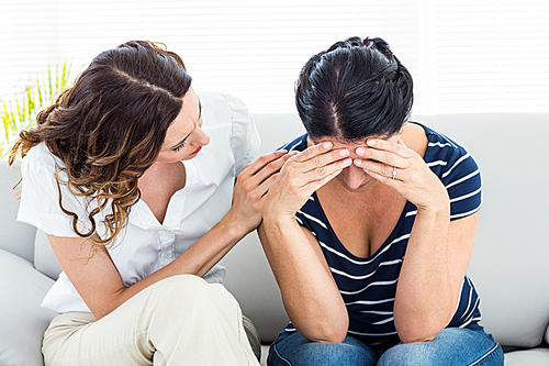 Therapist comforting her patient on white background