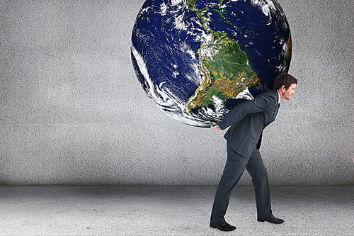 Composite image of businessman carrying the world