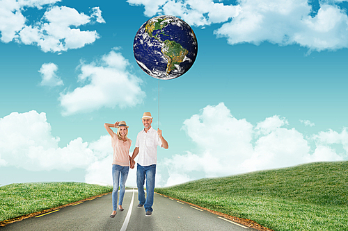 Composite image of happy couple walking holding hands