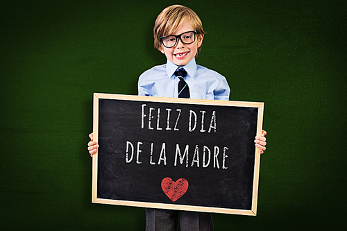 Composite image of cute pupil holding chalkboard