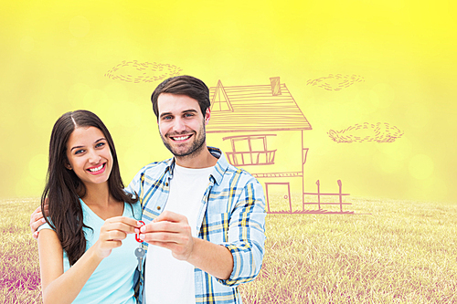 Composite image of happy young couple showing new house key