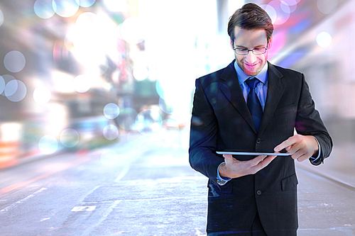 Composite image of businessman standing while using a tablet pc