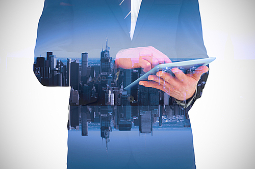 Composite image of businessman touching his tablet pc